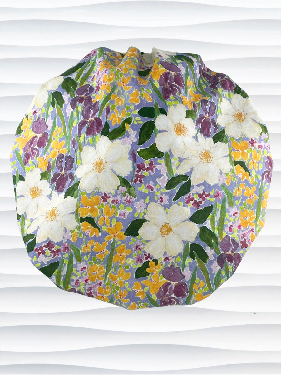 Bouffant style surgical scrub cap hat with Mardi Gras colors of yellows, greens, and purples on white cotton fabric.