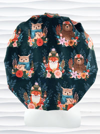 Bouffant surgical scrub cap hat with cute foxes, owls, and bears with flowers and leaves, hats and scarves on dark teal cotton fabric.