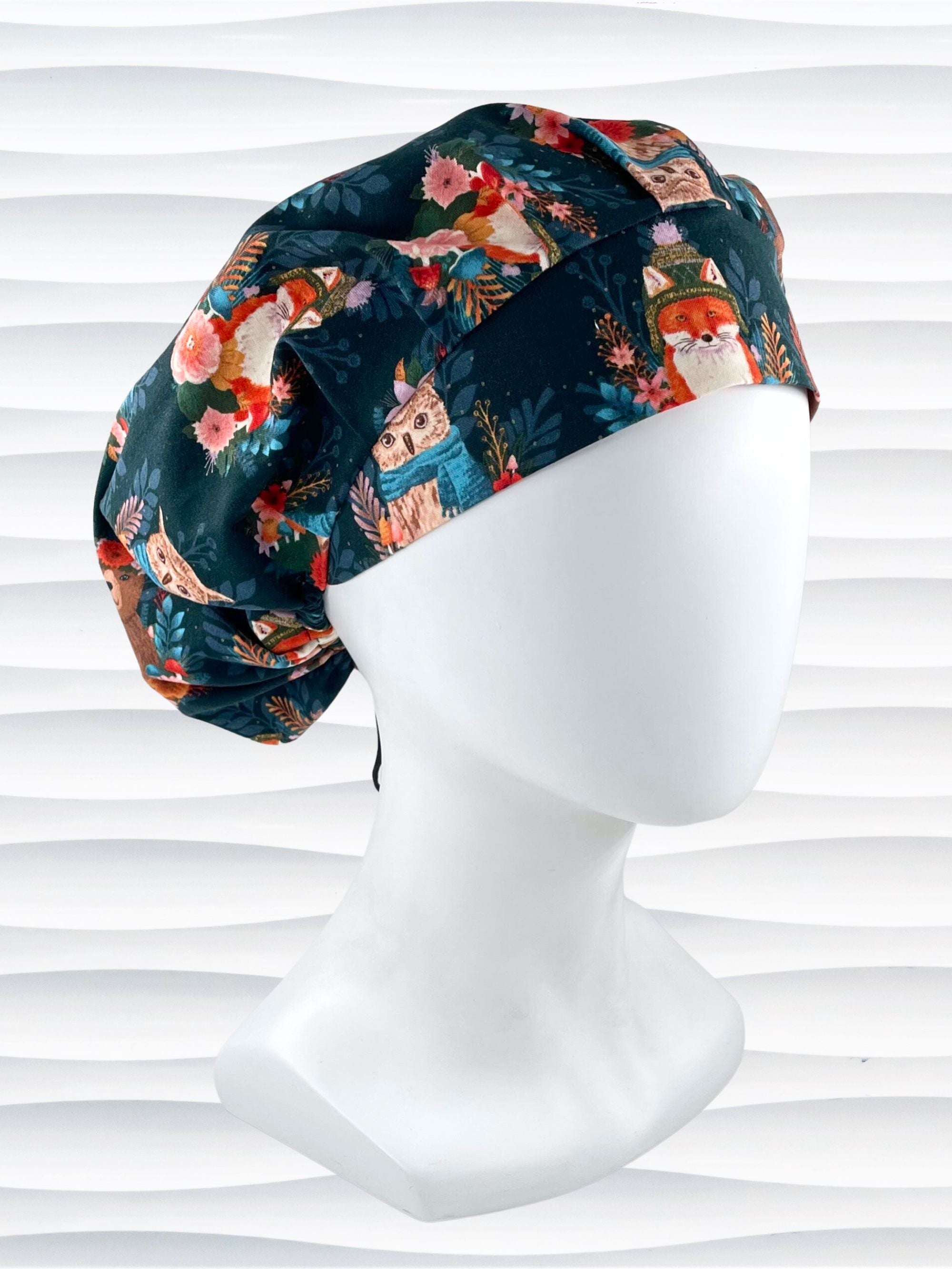 Bouffant surgical scrub cap hat with cute foxes, owls, and bears with flowers and leaves, hats and scarves on dark teal cotton fabric.