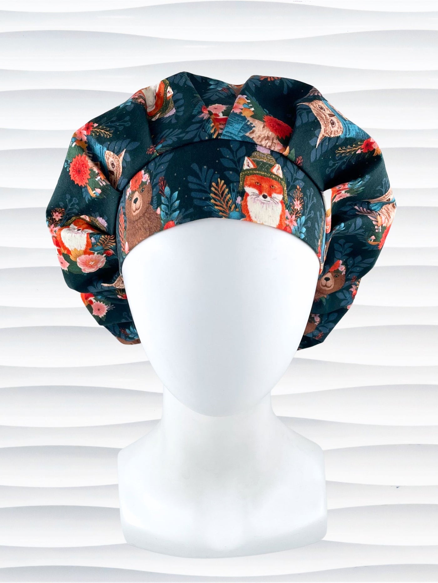 Bouffant surgical scrub cap hat with cute foxes, owls, and bears with flowers and leaves, hats and scarves on dark teal cotton fabric.