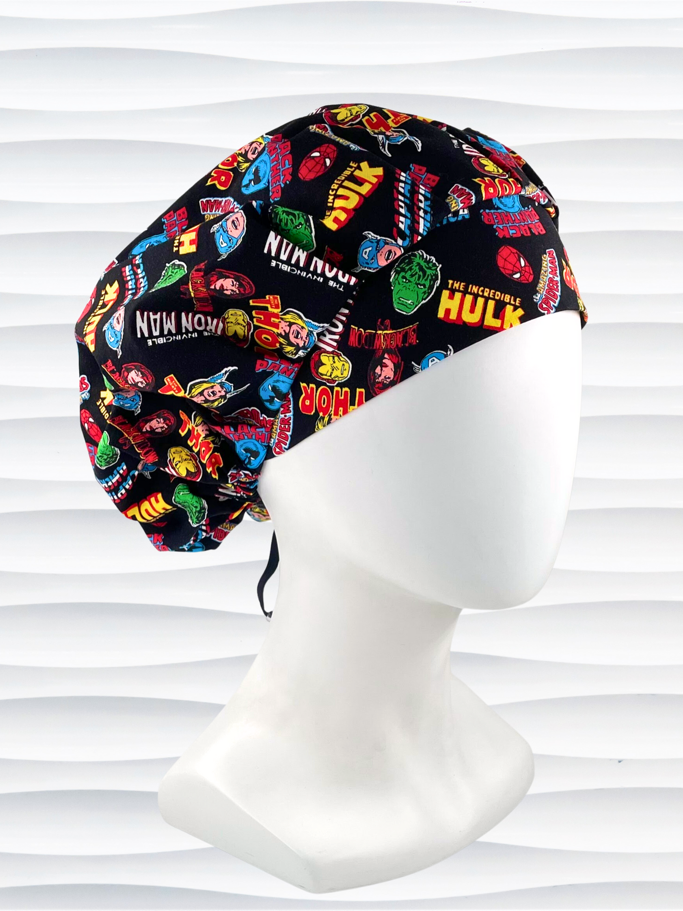 Bouffant style surgical scrub cap hat with Marvel Avengers superheroes all over this black cotton fabric.