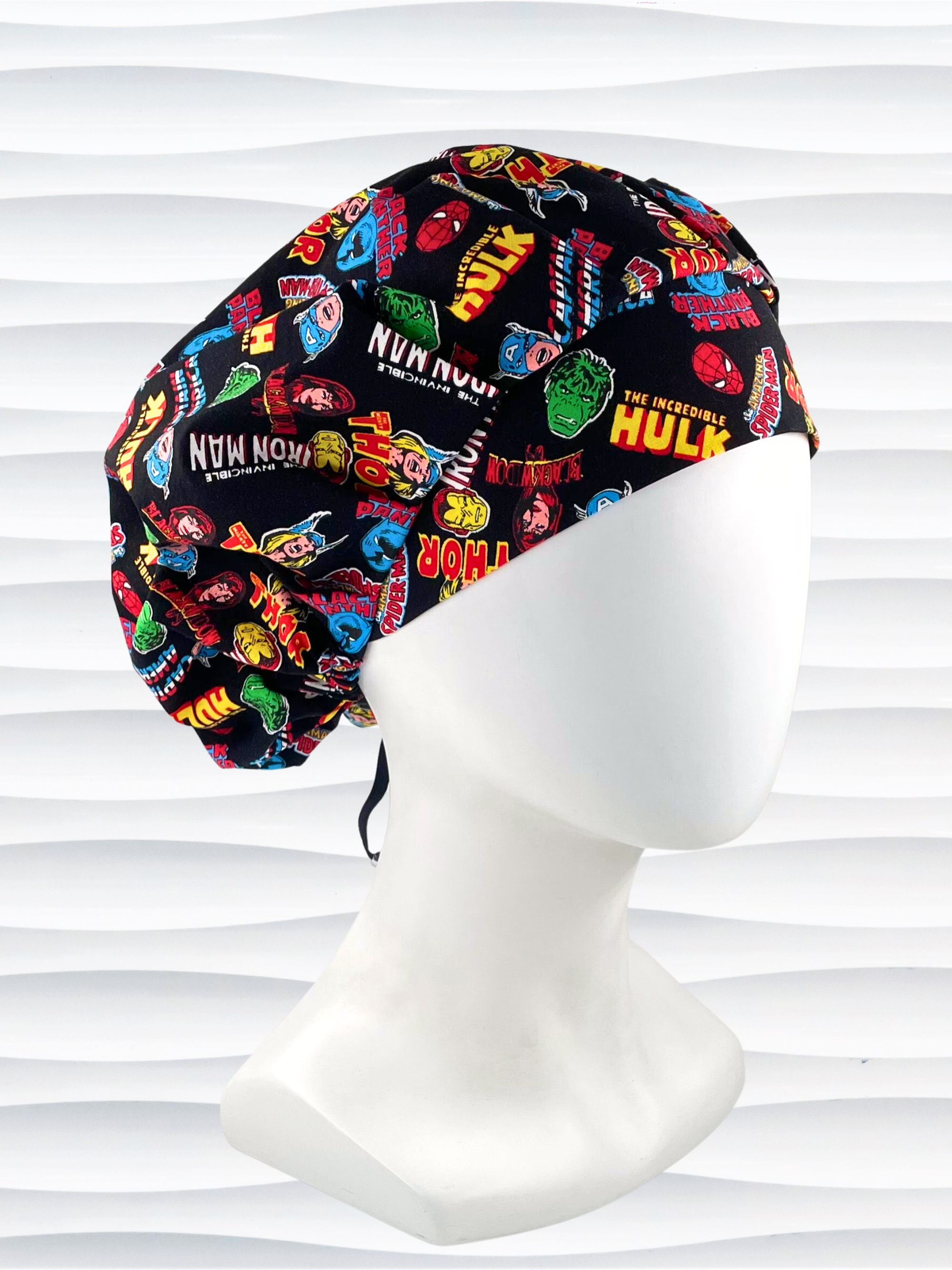 Bouffant style surgical scrub cap hat with Marvel Avengers superheroes all over this black cotton fabric.