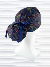 Ponytail style surgical scrub cap hat with bright colored dots and lines in diamond shapes on black cotton fabric.