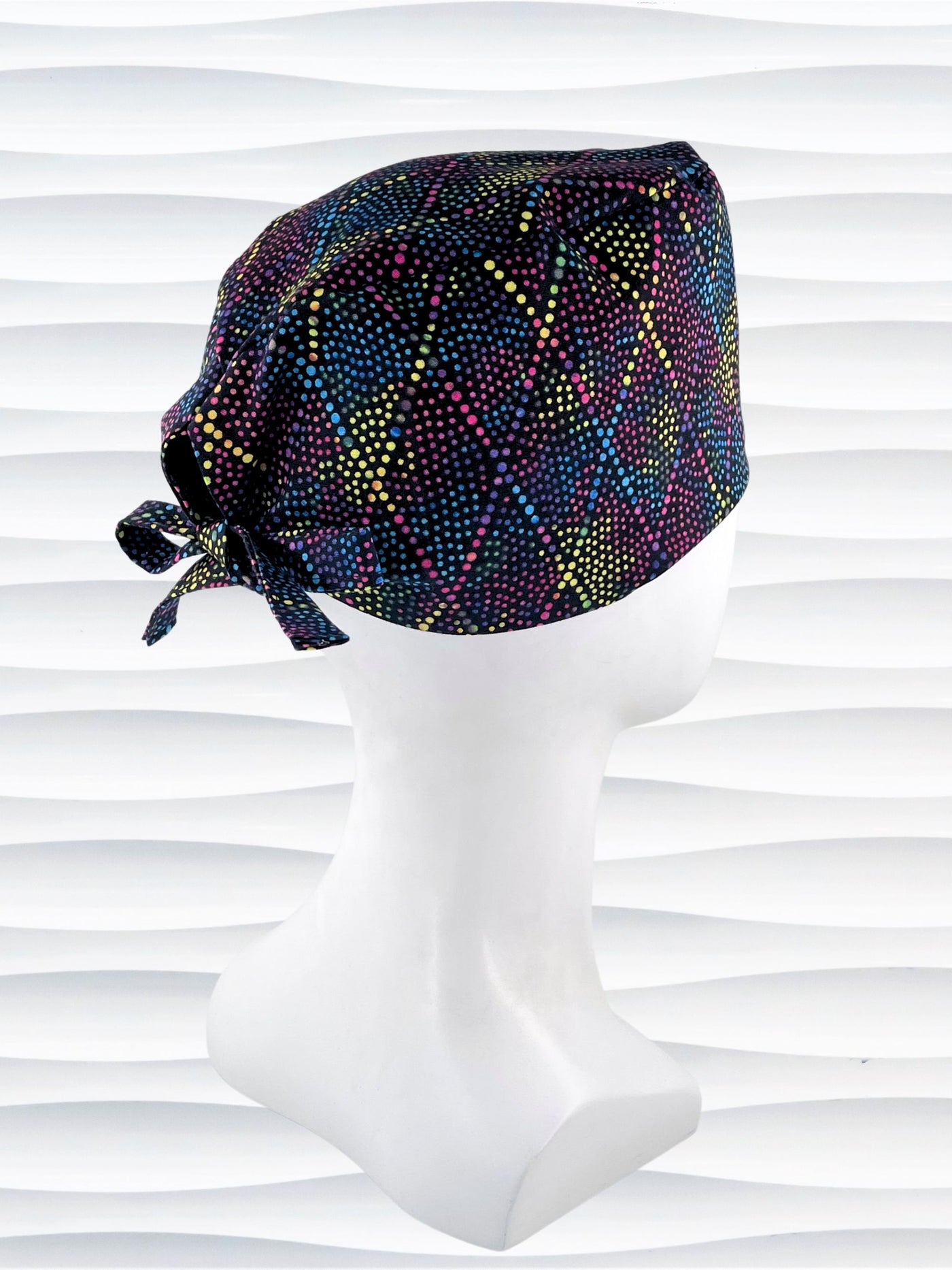 Surgeon Men's style surgical scrub cap hat with bright colored dots and lines in diamond shapes on black cotton fabric.