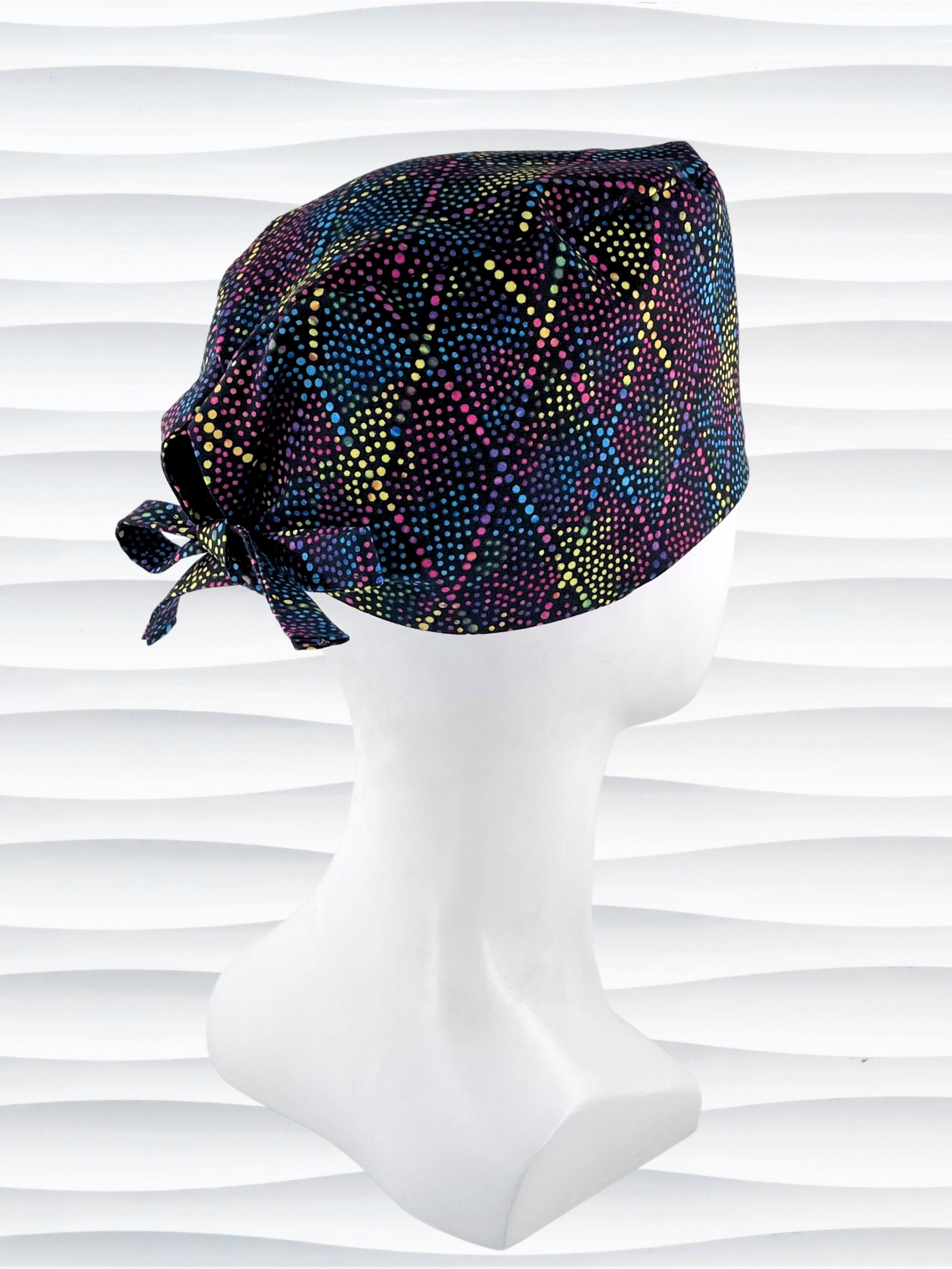 Surgeon Men's style surgical scrub cap hat with bright colored dots and lines in diamond shapes on black cotton fabric.