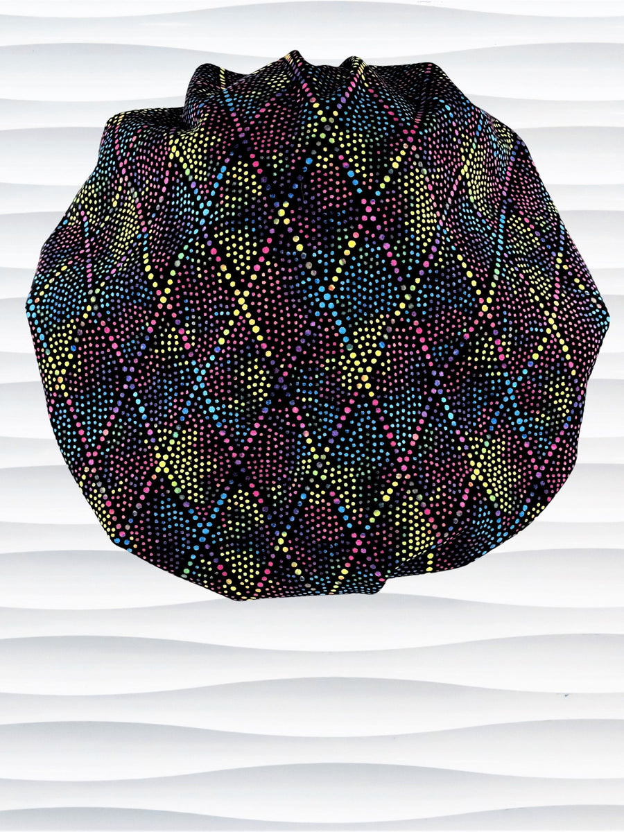 Bouffant style surgical scrub cap hat with abstract dots and lines in diamond shapes in bright colors on black cotton fabric.