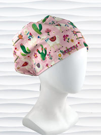 Pixie Euro style surgical scrub cap hat with white llamas wearing blankets, pink and blue flowers, and green cactus on pink cotton fabric.