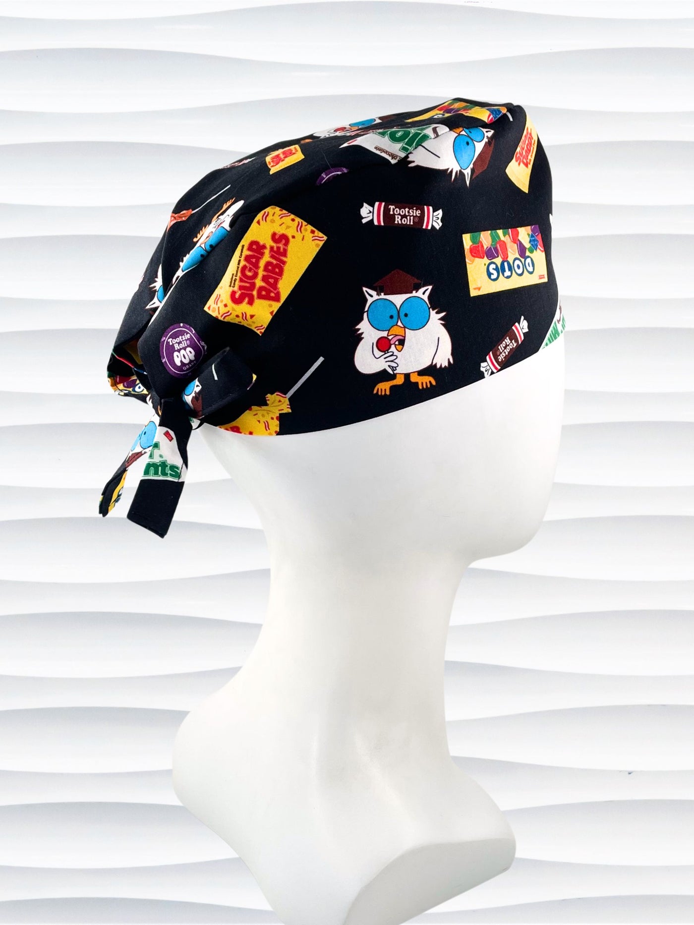 Surgeon style surgical scrub cap hat with iconic candies and Mr Owl on black cotton fabric.