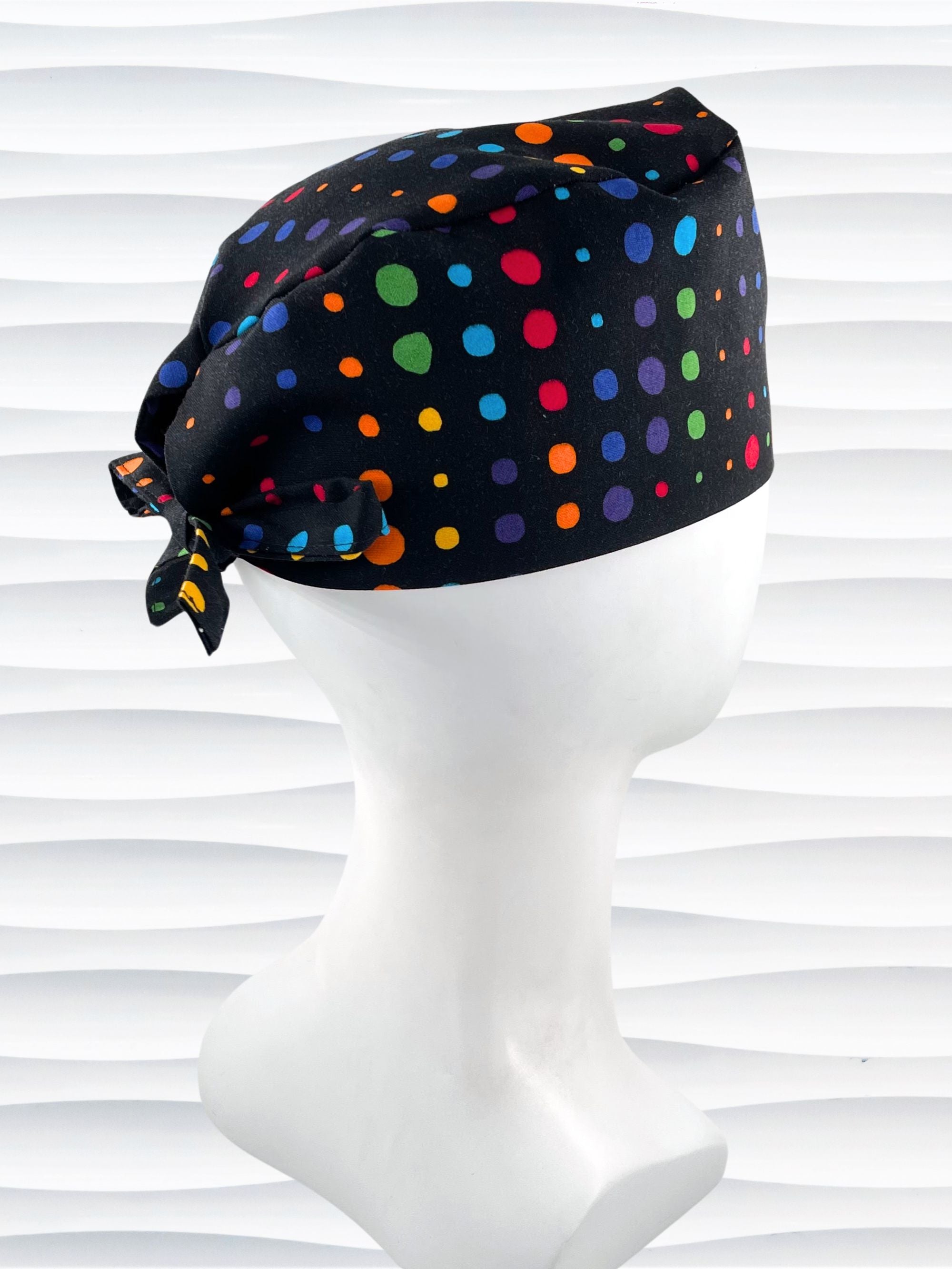 Surgeon style surgical scrub cap hat with bright colored linear dots on black cotton fabric.