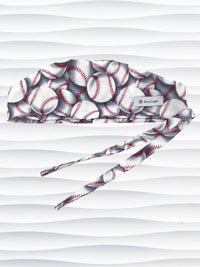 Surgeon style surgical scrub cap hat with an allover print of white baseballs with red stitching and gray shadows on cotton fabric.
