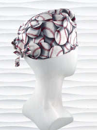 Surgeon style surgical scrub cap hat with an allover print of white baseballs with red stitching and gray shadows on cotton fabric.