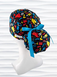Ponytail style surgical scrub cap hat with superhero masks and capes in red, blue, and yellow on black cotton fabric.